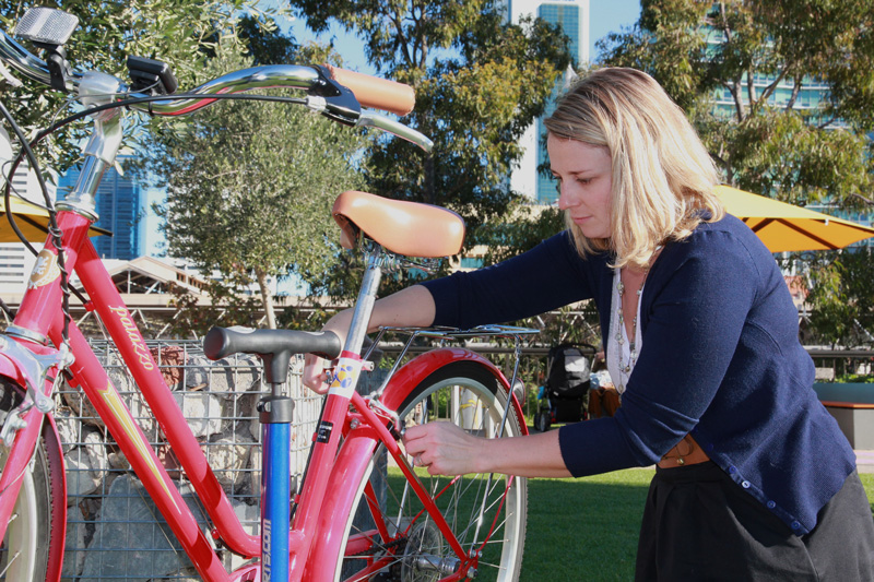 Young woman doing some basic bike maintenance
