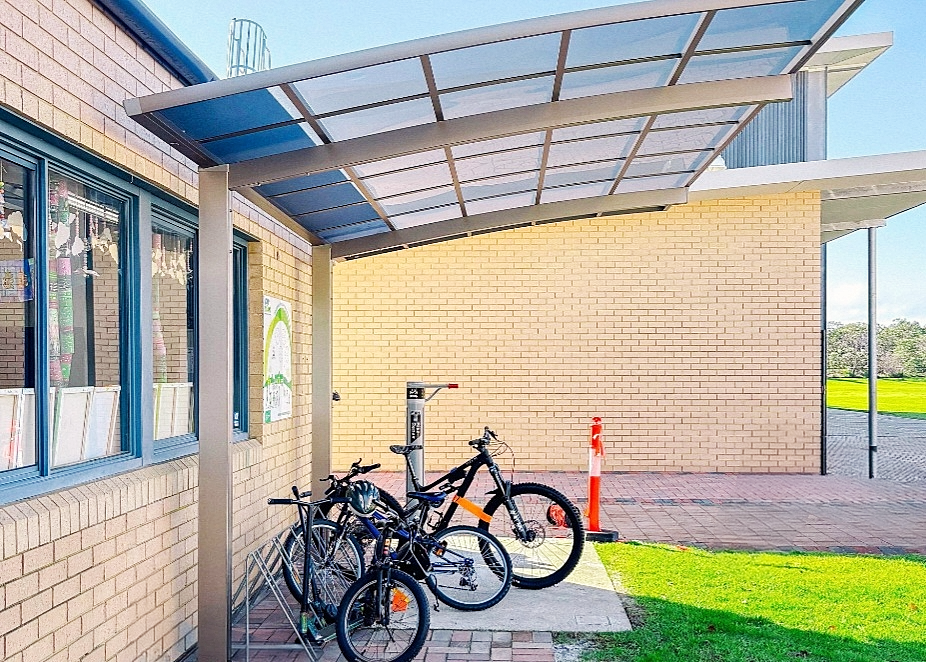 Bicycles parked under a bike shelter