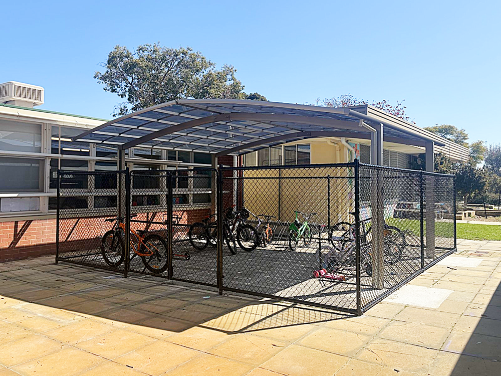 Lockable bike shelter outside a school classroom