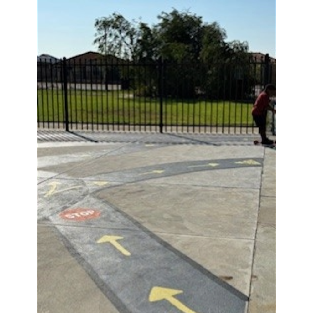 A bike track painted on a concrete playground